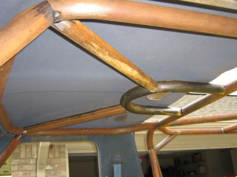 1986 Ford Bronco - Close-up view of custom roll cage tubing mounted within a vehicle's cabin.
