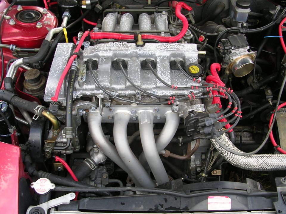 Engine looks to be fairly clean and dry.  No major oil leaks.  He said it was running OK before he parked it.  It has no battery and the MAIN fuse is blown.  He said it wouldn't start, but that may be because the MAIN fuse is blown :)  Has a Megan Racing header, EGR and O2 sensor are hooked up.  I believe the 96-97 PSE had a precat in the stock manifold, so this may be a problem with emissions if you have them.