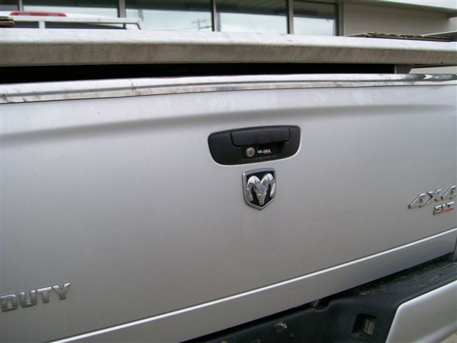 Tailgate of a silver 2005 Dodge 3500 pickup truck showing the Ram logo, '4x4' badge, and 'DUTY' text