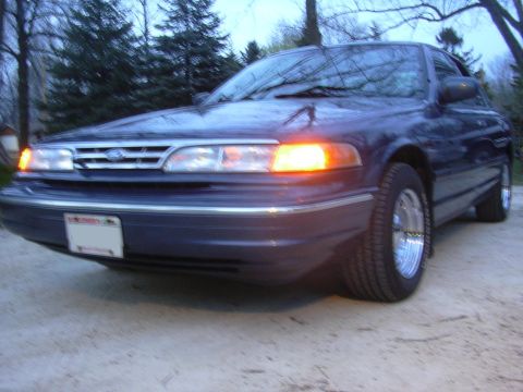 1996 Ford Crown Victoria - This 1996 Ford Crown Victoria is shown from a low front 3/4 angle with its driver's side turn signal illuminated.