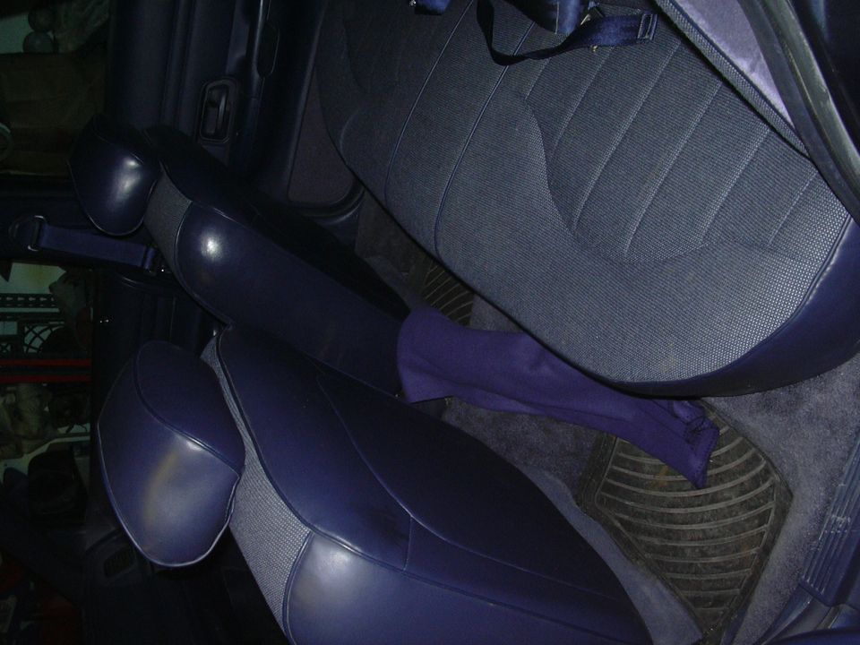 Interior view of dark blue cloth seats and dark blue vinyl trim