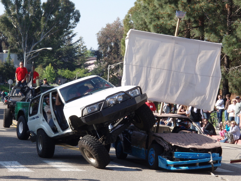 1993 Toyota 4Runner lifted high over a wrecked car on a parade float