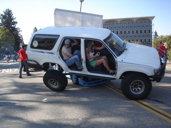 1993 Toyota 4Runner lifted onto a trailer with people inside, side view