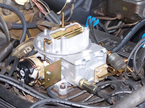 1973 Ford Ranchero - Engine bay detail showing a carburetor, fuel lines, and electrical connections.