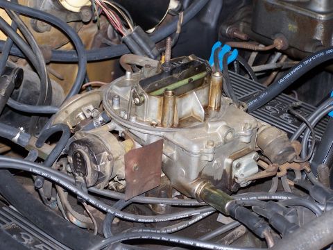 1973 Ford Ranchero - Close-up of a vehicle's carburetor, showing various hoses and wiring.