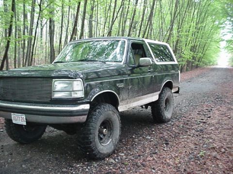 1993 Ford Bronco - This 1993 Ford Bronco is seen on a dirt road surrounded by trees.