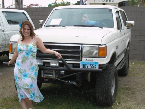1990 Ford Bronco - A woman poses with a lifted 1987 Ford Bronco, which has a custom front bumper and winch installed.