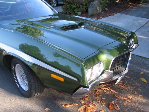 1992 Ford Mustang - Front view of a classic green muscle car, likely from the early 1970s, parked outdoors.