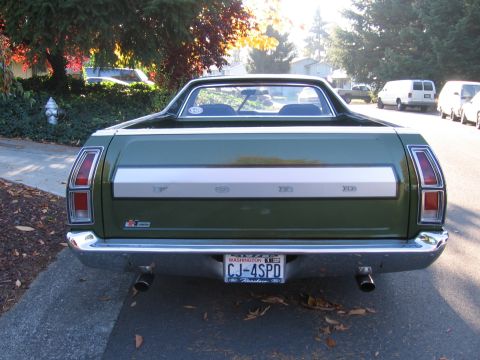 1992 Ford Mustang - Rear view of a green 1972 Ford Ranchero with a chrome bumper and dual exhaust pipes.