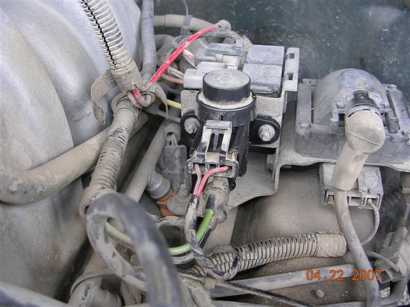 Engine component with red and green wired sensor, dated 2007