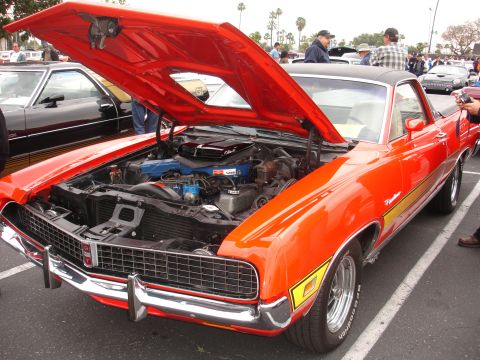 1993 Ford Taurus - This classic car is on display at an outdoor car show with other vehicles present.