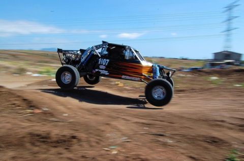 1992 Ford Explorer - A custom off-road buggy, marked with 1107, takes flight over a dirt track.