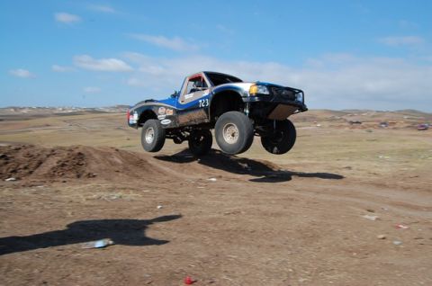 1992 Ford Explorer - This modified truck is mid-air during an off-road race.