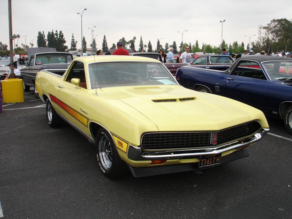 Yellow 1970 Ford Ranchero with red and orange stripes on the side