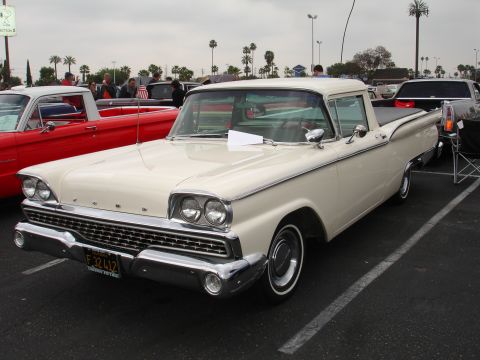 1993 Ford Taurus - A cream-colored 1959 Ford Ranchero pickup truck is parked next to a red vehicle.