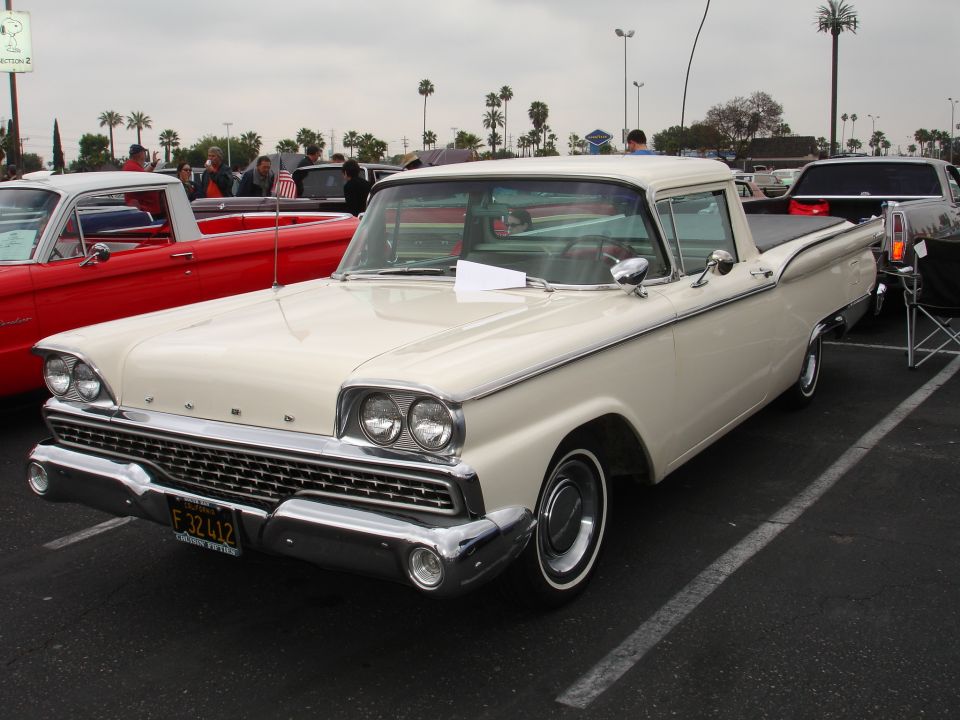 Cream-colored 1959 Ford Ranchero pickup truck, front 3/4 view, parked in a lot