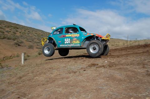 1992 Ford Explorer - This modified Volkswagen Beetle is mid-air during an off-road race, its racing modifications.
