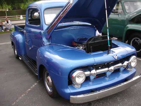 1993 Ford Taurus - Front view of a blue classic pickup truck with its hood open, revealing the engine bay.