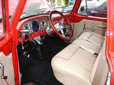 1993 Ford Taurus - Interior view of a vintage pickup truck with a red exterior and tan upholstery.