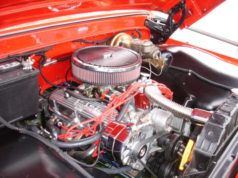 1993 Ford Taurus - Close-up view of a red engine bay, highlighting the 302 V8 engine and various chrome components.
