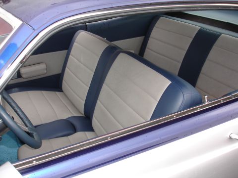 1993 Ford Taurus - Interior view of a car with two-tone bucket seats and a blue steering wheel.