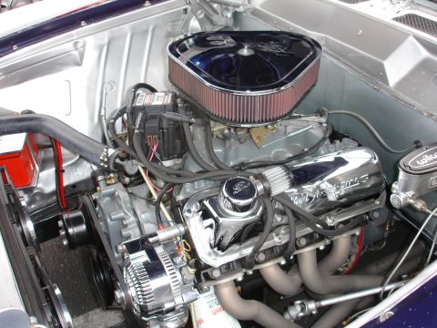 1993 Ford Taurus - Engine bay detail a Ford V8 with custom chrome components and aftermarket air intake.