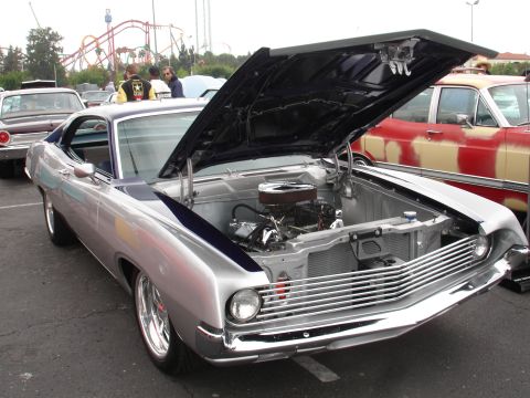 1993 Ford Taurus - A classic Ford Torino GT is displayed with its hood open, revealing the engine bay.