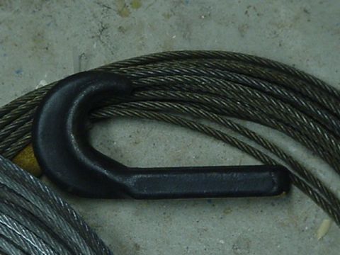 1993 Ford Bronco - A close-up view of a tow hook and steel cable on a concrete surface.