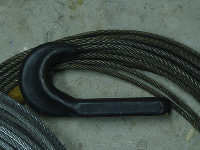 black tow hook next to coiled steel cable
