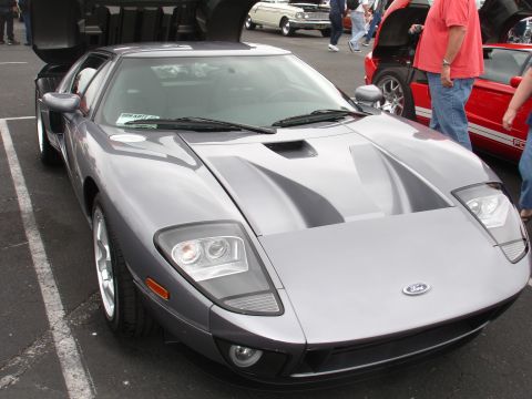 1993 Ford Taurus - A silver Ford GT is parked with its doors open, displaying its distinctive front-end design.