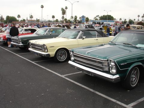 1993 Ford Taurus - A row of vintage Ford automobiles are displayed at an outdoor event.