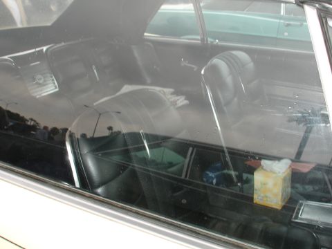 1993 Ford Taurus - View of a car's interior, including seats and a tissue box, with another vehicle seen outside.