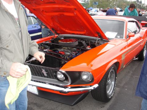 1993 Ford Taurus - This orange 1969 Ford Mustang Boss 302 is displayed with its hood open, revealing the engine compartment.