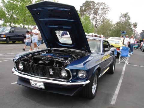 1993 Ford Taurus - A blue 1969 Ford Mustang is displayed with its hood open, revealing the engine compartment.