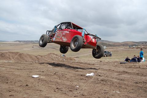 1992 Ford Explorer - A custom-built buggy soars through the air during an off-road event.
