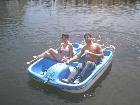 2005 Ford Excursion - A man and woman enjoy a day on the water in a pedal boat.