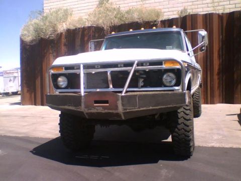 1973 Ford F-100 - Front view of a white 1973 Ford F-100 pickup truck with a custom heavy-duty bumper and off-road tires.