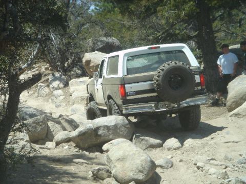 1994 Ford Bronco - A 1994 Ford Bronco tackles a challenging off-road course with large boulders.