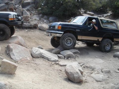 1994 Ford Bronco - Two Ford Broncos navigate a challenging rocky off-road course.