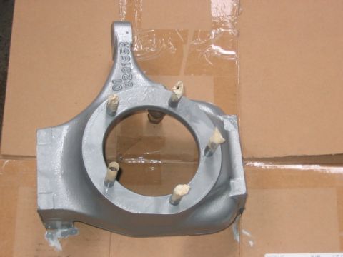 1991 Ford Bronco - A gray Dana 60 front axle housing with visible casting marks and wooden dowels is shown against a cardboard background.