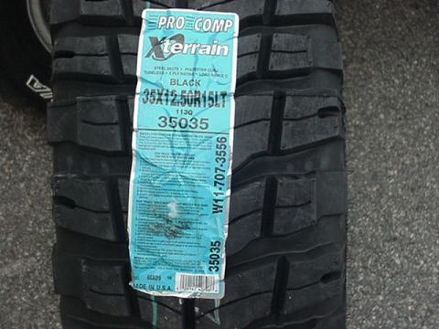 1993 Ford Bronco - New Pro Comp Xterrain mud-terrain tire lying on pavement with its factory label still attached, reading 35X12.50R15LT, load range C, 113Q,…