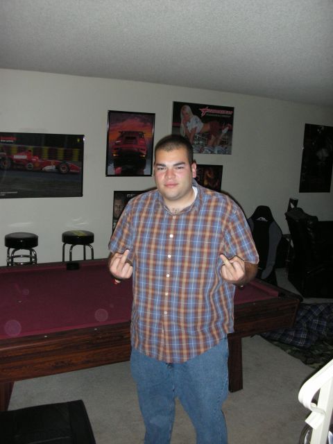 1992 Ford Crown Victoria - A man stands in a room with a pool table and several posters on the wall.