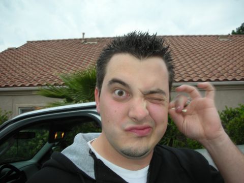 1992 Ford Crown Victoria - A man makes a humorous expression while standing in front of a house and a vehicle.
