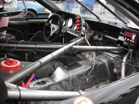 1992 Ford Crown Victoria - Interior view of a modified race car, showing extensive safety modifications and custom electronics.