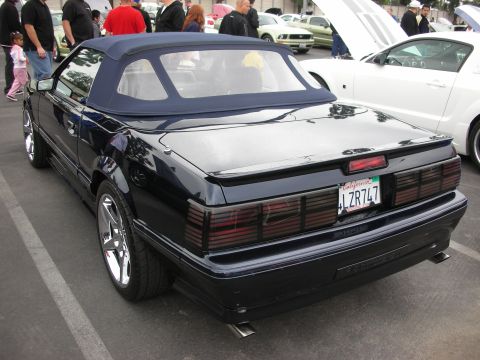 1992 Ford Crown Victoria - A dark blue convertible is seen from the rear at a car show, with a California license plate.