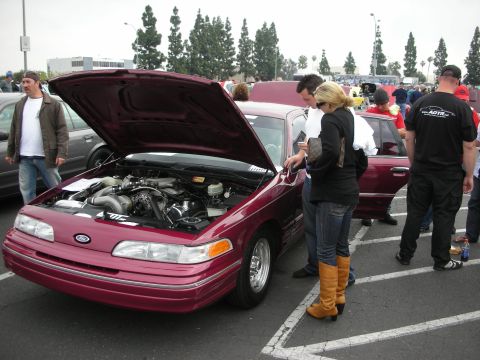 1992 Ford Crown Victoria - A maroon 1992 Ford Crown Victoria is displayed with its hood open, revealing the engine bay.