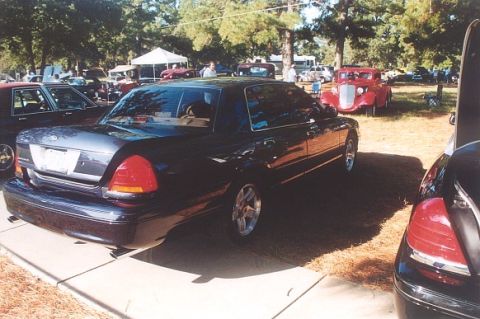 2002 Ford Crown Victoria - A 2002 Ford Crown Victoria is seen from the rear at an outdoor car show.