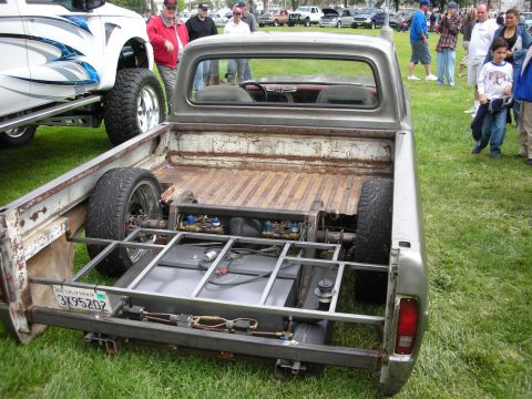 1992 Ford Crown Victoria - A custom pickup truck is displayed with its bed removed, revealing its modified chassis and fuel system.