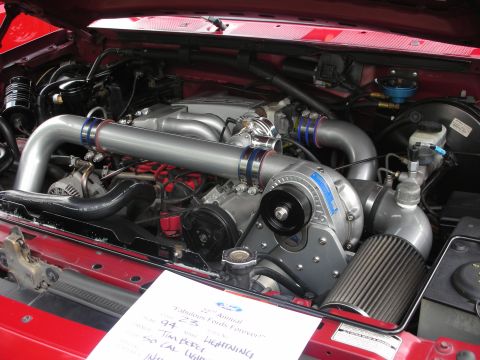 1992 Ford Crown Victoria - Close-up of a modified engine bay a prominent supercharger and polished intake tubes.