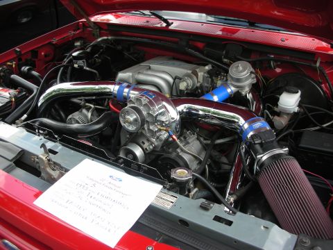 1992 Ford Crown Victoria - Engine bay features a polished supercharger and custom intake system, with a sign detailing event information.